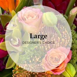 Mixed bouquet with pink roses and green buds under a "Large Designer's Choice" label