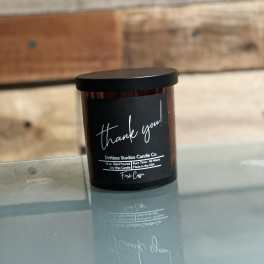 Black jar candle with a "thank you!" label