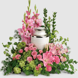 Pink floral funeral urn arrangement with lilies and roses