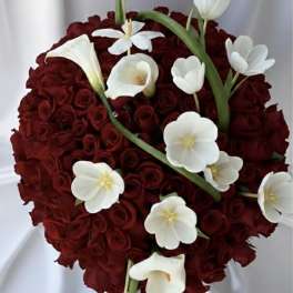 Heart-shaped bouquet of red roses with white calla lilies and tulips