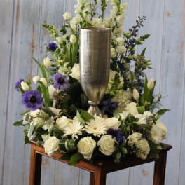 White and purple floral arrangement in a silver vase