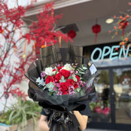 Bouquet of red roses with white blooms and pink filler flowers