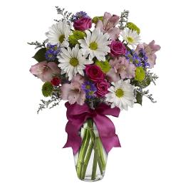 Bouquet of pink roses, daisies, and alstroemeria in a glass vase