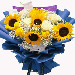 Bouquet of sunflowers and white roses wrapped in blue paper