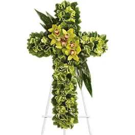 Green floral cross on a metal stand with yellow orchids