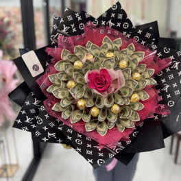 Bouquet with a pink rose, dollar bills, and gold chocolates in black patterned wrap