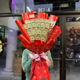 Bouquet of folded dollar bills wrapped in red paper with a ribbon