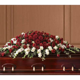Red and white floral casket spray with roses and carnations