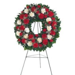 Red and white floral wreath on a standing easel