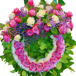 Heart-shaped rose wreath with pink, white, and purple blooms