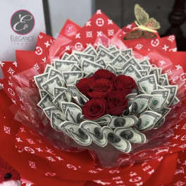 Red roses arranged with folded dollar bills in red wrapping