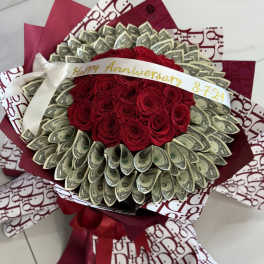 Bouquet of red roses wrapped with dollar bills and burgundy paper