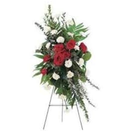 Standing floral spray with red and white flowers on an easel