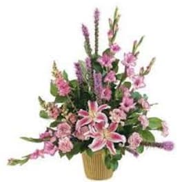 Pink lilies and mixed pink flowers in a gold vase