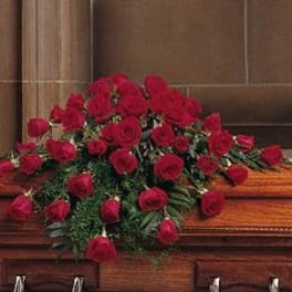 Casket spray of red roses with greenery