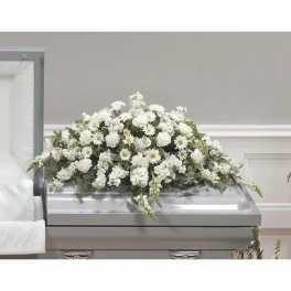 White floral casket spray with daisies and carnations