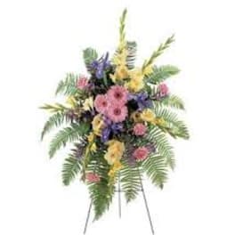 Standing floral spray with pink, yellow, and purple flowers
