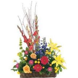 Colorful mixed flower arrangement in a wicker basket