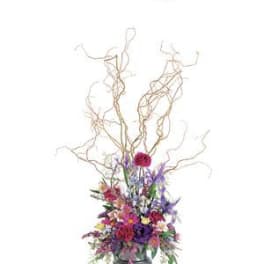 Tall floral arrangement with colorful blooms in a silver vase