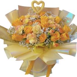 Bouquet of yellow and peach roses with baby’s breath in iridescent wrap