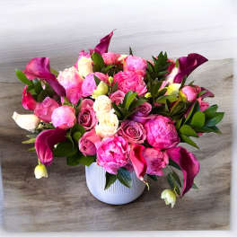 Pink and white floral arrangement in a white vase
