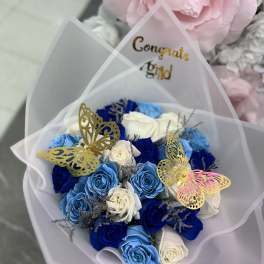 Bouquet of blue and white roses with butterfly picks
