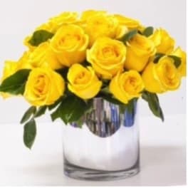 Yellow roses arranged in a clear glass vase