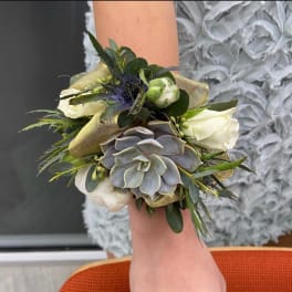 Succulent wrist corsage with white blooms and gold ribbon