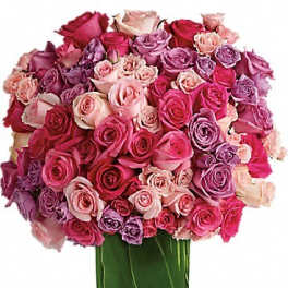 Large bouquet of pink and purple roses in a glass vase
