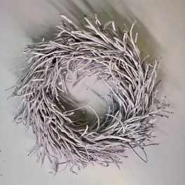 A white twig wreath with a circular opening