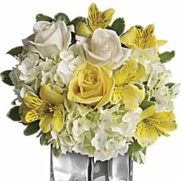 Yellow and white rose bouquet in a clear square vase
