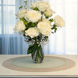White roses arranged in a clear glass vase