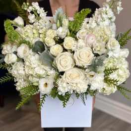 White rose and lisianthus bouquet in a white box