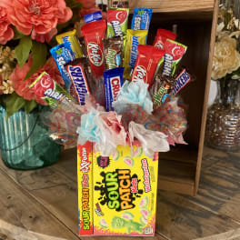 Candy bouquet in a Sour Patch Kids box with colorful wrapped sweets