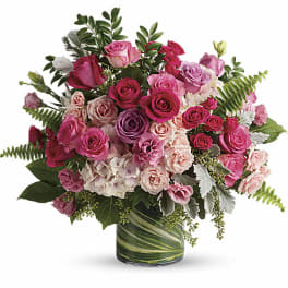 Pink and lavender rose bouquet in a glass vase