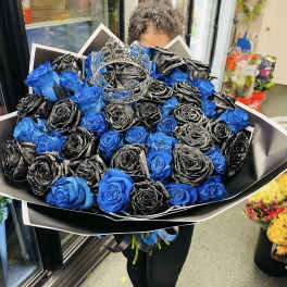 Bouquet of blue and black roses with a silver crown topper