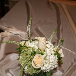 Cream roses and white hydrangeas in a square glass vase