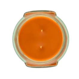 Orange candle in a clear glass container