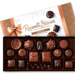 Box of assorted chocolates with a ribboned lid