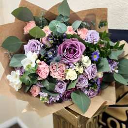Bouquet of lavender and pink roses with small purple flowers