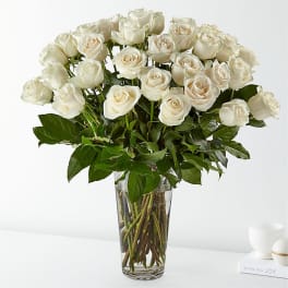Bouquet of white roses in a clear glass vase