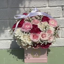 Pink and white rose bouquet in a pink box with a ribbon bow