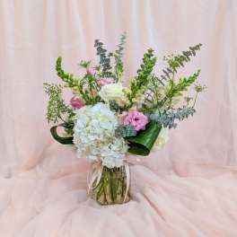Bouquet of white and pink flowers in a glass vase