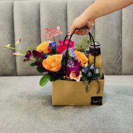 Flower gift bag with roses and a drink bottle
