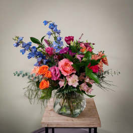 Mixed bouquet of colorful flowers in a clear glass vase