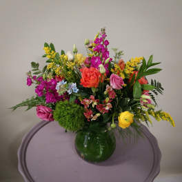 Mixed bouquet of colorful flowers in a glass vase