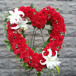 Heart-shaped red carnation wreath with white lilies