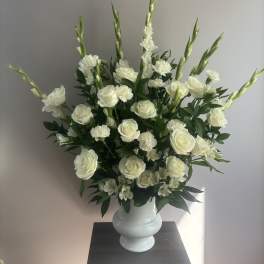 White roses and carnations in a white vase