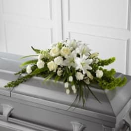White floral spray on a gray casket