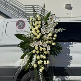 Large white floral standing spray with roses and orchids